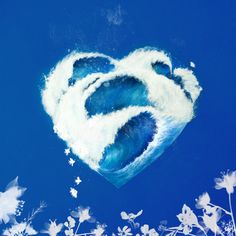 a heart shaped cloud floating in the air with white flowers around it on a blue sky background