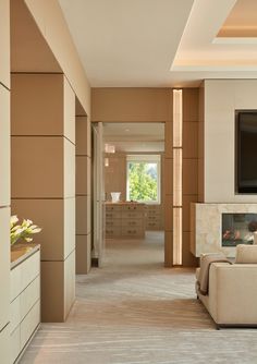 a living room with couches and a flat screen tv mounted on the wall in front of a fireplace