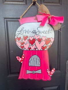 a door hanger that says love is sweet