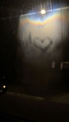 the light is shining brightly on the wall in the dark room, and it appears to be heart shaped