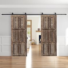 an open door with wooden paneling on the side and wood floors in front of it