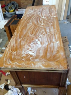 a wooden table with white paint on it