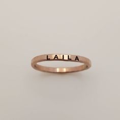 Mother's Day Gift | Personalized stackable ring, engraved with a name, date, or special word. This listing is for a 14k rose gold filled ring, but we do have listings for fine silver and gold filled as well. Metal: 14k rose gold filled  Dimensions: 2mm tall on average, but our rings are handmade so variations will occur. Font: uppercase thick block Unsure what size you need? We highly recommend using our ring sizer for an accurate fit. Some people find that sizing up when stacking 3 or more ring Personalized Adjustable Stackable Rings, Minimalist Jewelry With Custom Text For Anniversary, Minimalist Customizable Initial Ring For Promise, Customizable Minimalist Engraved Promise Ring, Minimalist Customizable Initial Ring, Adjustable Hand Stamped Initial Ring Minimalist, Adjustable Hand Stamped Minimalist Initial Ring, Adjustable Minimalist Hand Stamped Initial Ring, Personalized Rose Gold Engraved Ring For Promise