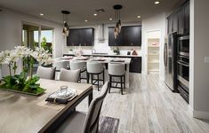 a large kitchen and dining room are shown in this house's new model home