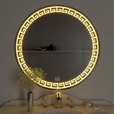 a bathroom sink with a lighted mirror on it's side next to a vase