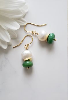 These are very adorable and easy to match any designs wire wrapped genuine Chrysoprase Plain Smooth Roundelle Dangle Earrings (stone size is 11-12 mm) in combination with White Freshwater Pearl beads (stone size is 10-11 mm) with Gold Vermeil wavy disk spacer beads. All metal components are solid 925 Sterling Silver plated with 24K gold (Vermeil). These earrings are 2.5 centimeters long. Chrysoprase Smooth Roundelle: 11-12 mm, Africa, Grade AA White Freshwater Pearl beads: 10-11 mm, Peru, Grade AA Designed and Made by AnGjewelry! They will be delivered in a cute gift box! ♡ The Chrysoprase stone is one of the best antidepressants in the world of crystal healing. Cooling and calming this gemstone was a favorite of Alexander the Great. Green Onyx Drop Earrings For Gifts, Green Onyx Earrings For May Birthstone Gift, Green Onyx Dangle Earrings Gift, Green Onyx Dangle Jewelry For Gift, Round Chrysoprase Earrings Gift, Green Gemstone Drop Pearl Earrings, Green Gemstone Pearl Drop Earrings, Jade Earrings With Ear Wire For May Birthstone, Handmade Elegant Chrysoprase Earrings