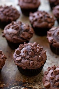 chocolate cupcakes are sitting on a baking sheet