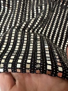 "Good quality and fast shipping." Angela K. Verified Kikitextiles Customer ✅ Bring on the shimmer with our very sparkly Metallic Flat Sequins on Black Glittery Knit. At full glimmer, this medium-weight sequined fabric is a 4 way stretch. Fully opaque, this fabric doesn't require a lining.This fabric is made up of a combination of materials including nylon spandex and sequins. The fabric has a shiny, reflective surface due to the presence of small mirror-like sequins that are attached to it. The Holiday Disco Sequin Fabric With Glitter, Black Glitter Sequin Fabric For Festive, Black Glitter Sequin Fabric For Festive Occasions, Shiny Metallic Sequin Fabric For Evening, Metallic Shiny Sequin Fabric For Evening, Glamorous Sparkling Metallic Sequin Fabric, Sparkling Metallic Sequin Fabric For Night Out, Glamorous Metallic Shiny Sequin Fabric, Glamorous Metallic Sequin Fabric