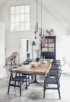 a dining room table with chairs and a book shelf