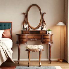 a bedroom with a bed, dresser and mirror on the wall next to a chair