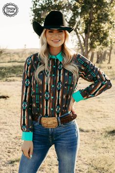 Navigate your way in style with our Red Dirt Road Top! This chic western style shirt has a gray button up, turquoise pearl snaps, and an awesome aztec design with a dash of color from the turquoise collar and cuffs. Lookin' sharp! 95% Polyester 5% spandex SIZE CHEST LENGTH SLEEVE WIDTH SLEEVE LENGTH XS 18.5" 27.5" 5" 24" S 20.5" 28" 5.25" 24.5" M 21" 29" 5.5" 25" L 21.25" 29.5" 5.5" 25.5" XL 23" 30" 6" 25.5" 2X 24" 30.5" 6.5" 25.5" 3X 26.5" 31" 6.5" 26" Southwestern Clothing, Western Style Shirt, Cute Country Outfits, Red Dirt, Singlet Tops, Aztec Design, Dirt Road, Aztec Designs, Cap Dress