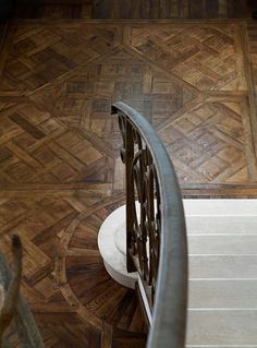 an aerial view of a wooden floor and railing