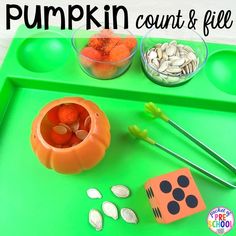 a green tray with pumpkins, coins and spoons on it that says pumpkin count & fill