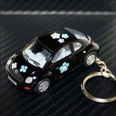 a car keychain with flowers painted on it