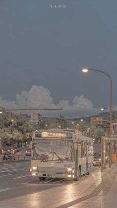 a bus driving down the street at night