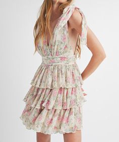 This gorgeous floral print mini dress features a v-neckline, a tiered body, a smocked waistband and self tie straps. Feminine and chic, this dress is perfect for day or night. 100% polyester Lined Self tie straps V-front and back Model is wearing a size small and is 5'10" FINAL SALE - CANNOT BE RETURNED OR EXCHANGED Spring Tiered Dress With Tie Straps, Chic Floral Print Tiered Dress, Feminine V-neck Tiered Summer Dress, Spring Tiered Tie Back Dress, Tiered Brunch Dresses With Tie Straps, Chic Floral Print Tiered Dress For Garden Party, Feminine Tiered Sundress For Garden Party, Chic Floral Print Tiered Dress For Brunch, Spring V-neck Mini Dress With Tie Straps