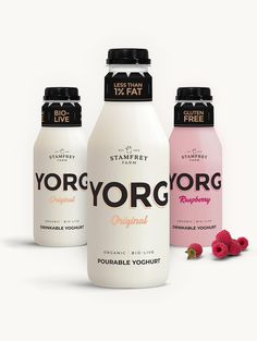 three bottles of yogurt and raspberry on a white background with berries