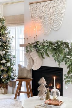 a living room decorated for christmas with stockings and candles