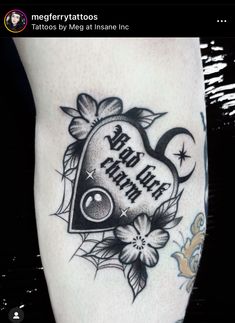 a black and white tattoo design on the leg