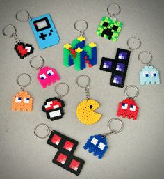 a bunch of pixel keychains that are on a table