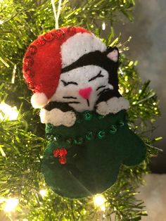 a cat ornament hanging from a christmas tree