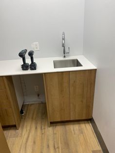 an empty kitchen with wooden floors and white walls