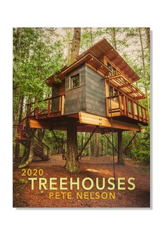 the cover of treehousees magazine featuring a tree house in the middle of a forest