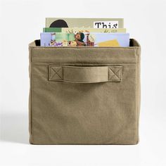 an open canvas bag with books in it on a white background, showing the inside pocket