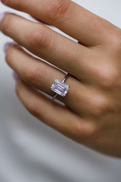 a woman's hand with a diamond ring on it