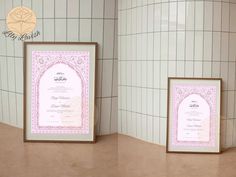 there are two framed diplomas on the counter next to each other in front of a tiled wall