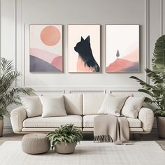 a living room with three paintings on the wall