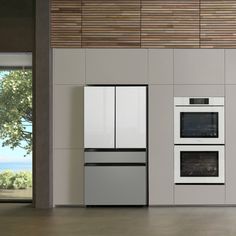 a kitchen with two ovens and a stove in it's center, next to a window