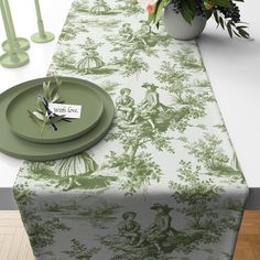 a table topped with a green and white place setting