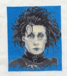 a cross stitch picture of a man with curly hair