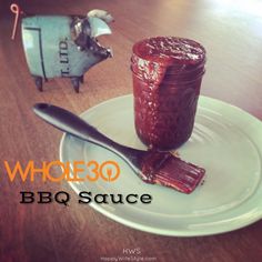 there is a small plastic animal next to a jar of bbq sauce on a plate