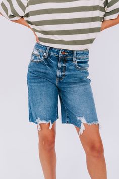 Get ready for a summer to remember with these playful high rise denim shorts. The rips and fraying at the bottom add a touch of edge and uniqueness, making these shorts a staple for any summer wardrobe. (Plus, they'll keep you looking cool while staying cool!) Details High rise fit Denim Rips/fraying at the bottom Sizing Approximate measurements: SIZE LENGTH/INSEAM WAIST Small 18/11" 30" Medium 19/11" 32" Large 19/11" 34" Fabric has stretchModel is 5’8 wearing small Material 97% Cotton 2% Elaste Medium Wash Bermuda Shorts With Frayed Hem For Spring, Cotton Bermuda Shorts With Frayed Hem Cutoff, Cotton Bermuda Shorts With Frayed Hem And Cutoff Shape, Relaxed Fit High-waisted Jean Shorts With Frayed Hem, High-waisted Jean Shorts With Frayed Hem In Relaxed Fit, Summer Bermuda Shorts With Frayed Hem In Medium Wash, Distressed Cotton Cutoff Shorts, Medium Wash Cutoff Bermuda Shorts For Spring, Cutoff Denim Bermuda Shorts For Spring