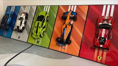 a group of race cars hanging on the side of a wall