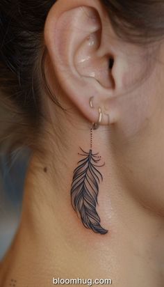 a woman's ear with a tattoo on it