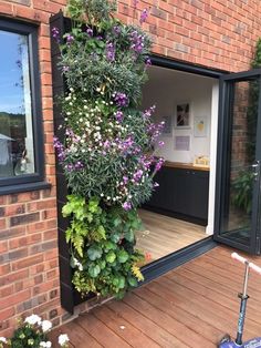 an outside view of a house with flowers growing on the wall