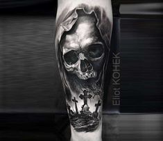 a man's leg with a skull and cross tattoo on it