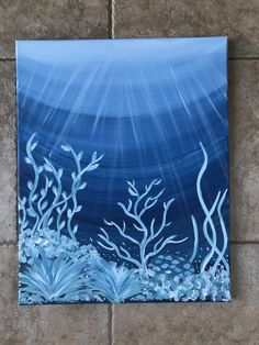 an acrylic painting of seaweed and corals on a tile wall in a bathroom