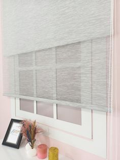 a window with blinds in a pink room