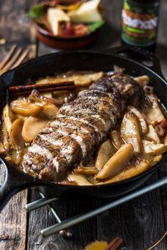 an iron skillet filled with meat and potatoes