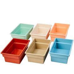 six different colored plastic containers sitting next to each other