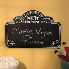 a chalkboard sign that says movie night on it