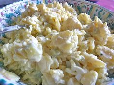 a bowl filled with macaroni and cheese on top of a table