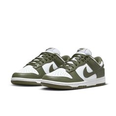 The Nike Women's Dunk Low 'Medium Olive' is the perfect blend of archival hoops style and contemporary design. Showcasing a classic two-tone color scheme, these comfortable sneakers feature a crisp white base with olive green overlays for added depth. The Nike Swoosh further accents the design in color-matched detail. Underpinned by a traditional rubber cupsole, the cushioning foam wedge provides superior comfort and impact protection, while the olive outsole ensures reliable traction when on the court. This updated version of the iconic Be True to Your School series from 1985 delivers timeless appeal with modern performance tech that make sure you stand out in style and comfort. Nike Dunk Low Medium Olive, Kitty Pictures, Sneaker Trend, Nike Model, Nike Models, Cargo Khaki, Baskets Nike, Adidas Spezial, Sports Trainers