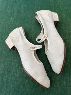 When I say sport shoes, sports for women in the 1920s was still an endeavour on dressed for.  Golf was played in skirts with shirts, ties and cardigans; tennis was played in beautiful drop waist dresses; victorian women mountaineers still wore full skirts and corsetry.  These shoes might have been worn on the tennis court or for a walk.  They have a low 1 inch/25mm squat heel.  They are made from a canvas.  They have a roundish toe and a single strap with a button closure.  There is a fine trim Vintage Fitted Closed Toe Dance Shoes, Classic Closed Toe Dance Shoes For Spring, Vintage Fitted Dance Shoes With Low Heel, Fitted Vintage Dance Shoes With Low Heel, Vintage Dance Shoes With Leather Sole And Round Toe, Vintage Closed Toe Dance Shoes With Leather Sole, Skirts With Shirts, Dresses Victorian, Shoes Mary Jane