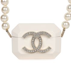 This Chanel resin crystal pearl Airpod Pro case necklace is crafted from resin material with a large gold and crystal CC on the front of the Airpod case. The case features a long single strand of pearls and an interwoven chain of light gold tone and black lambskin leather to be worn as a strap or a necklace. This necklace also features an opening on the base for a charging cord.Collection: 2021Origin: ItalyCondition: New and never wornAccompanied by: Chanel pouch, ribbon and carebookMeasurements Chanel Pouch, Strand Of Pearls, Airpod Pro Case, Airpod Pro, Pearl Bag, Charging Cord, Airpod Case, Resin Material, Vintage Pearls