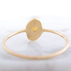 Delicate gold opal ring, October Birthstone ring. This ring is handcrafted in 14k gold. Setting around the stone is hammered and the ring holds tiny secret heart in the back. Perfect gift for your Mom, Sister or Anniversary ring for Wife. CENTRAL STONE: *natural, Earth mined Ethiopian opal *the setting around the stone is hammered *opal with setting measures approximately: 5.2mm X 7.1mm SPECIFICATIONS: * band: approximately 1 mm, high polish * material: 14k yellow gold * size: available in reque Gold 14k Opal Ring As Gift, 14k Gold Opal Ring For Gift, Minimalist 14k Gold Oval Cabochon Jewelry, Yellow Gold Moonstone Oval Cabochon Ring Gift, Yellow Gold Polished Opal Ring, Minimalist Gold Opal Rings, Adjustable 14k Gold Oval Opal Ring, Adjustable 14k Gold Opal Ring, Gold Opal Stackable Ring With Oval Shape